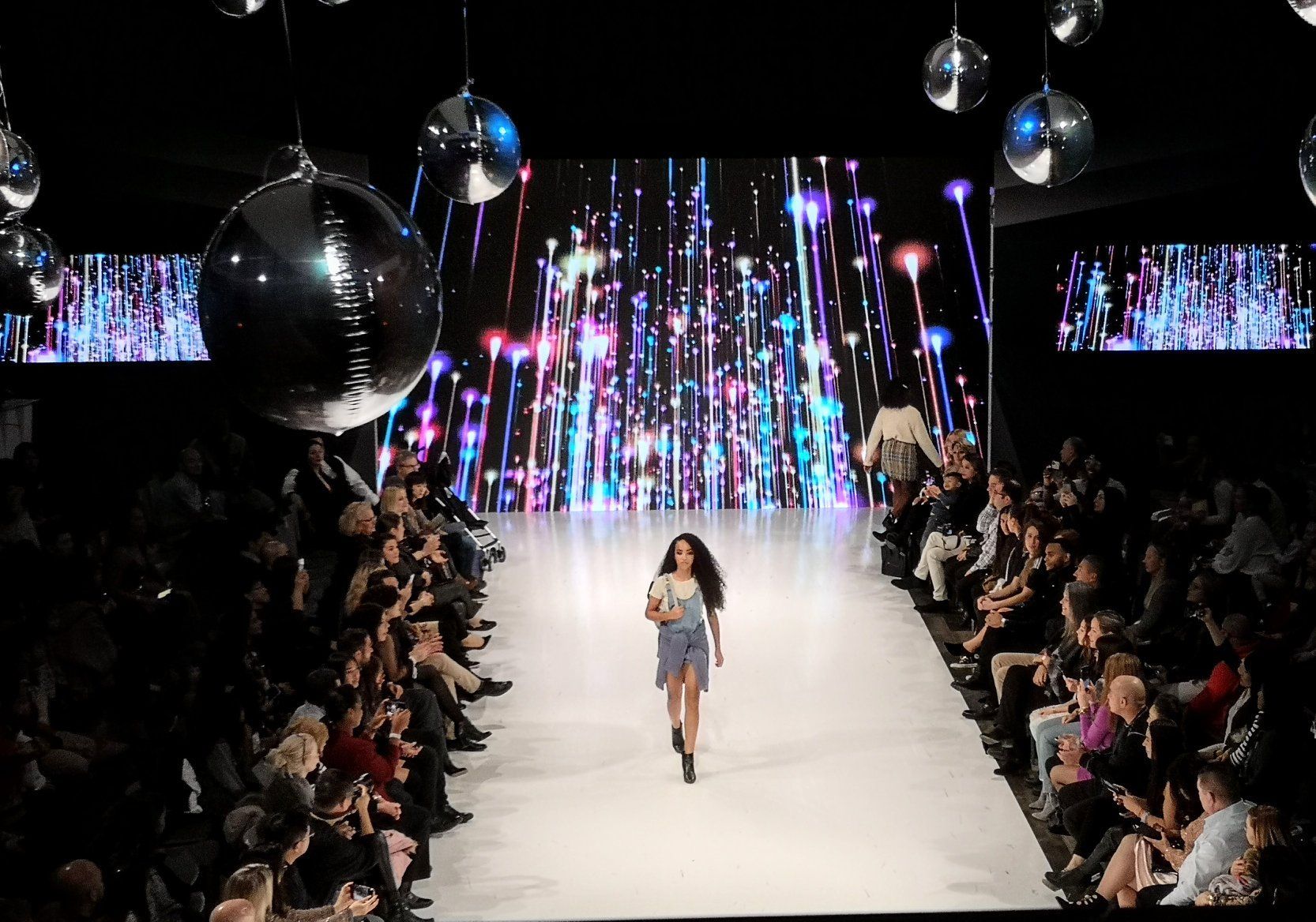 A model walks down the runway at a fashion show