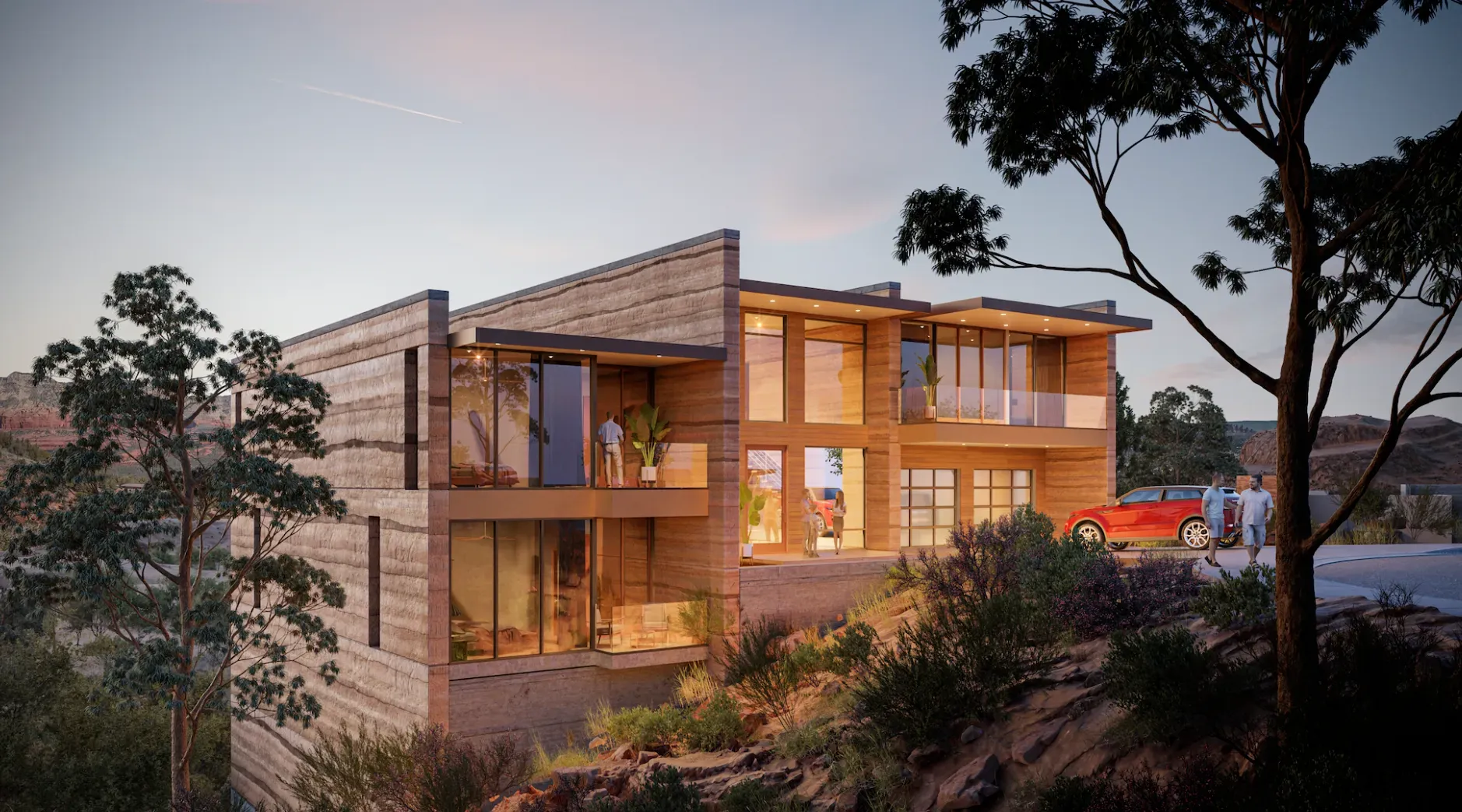 Wooden house with large windows glowing at dusk