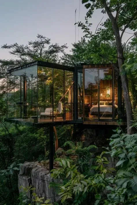 Glass-walled treehouse glowing warmly among lush tropical trees at dusk