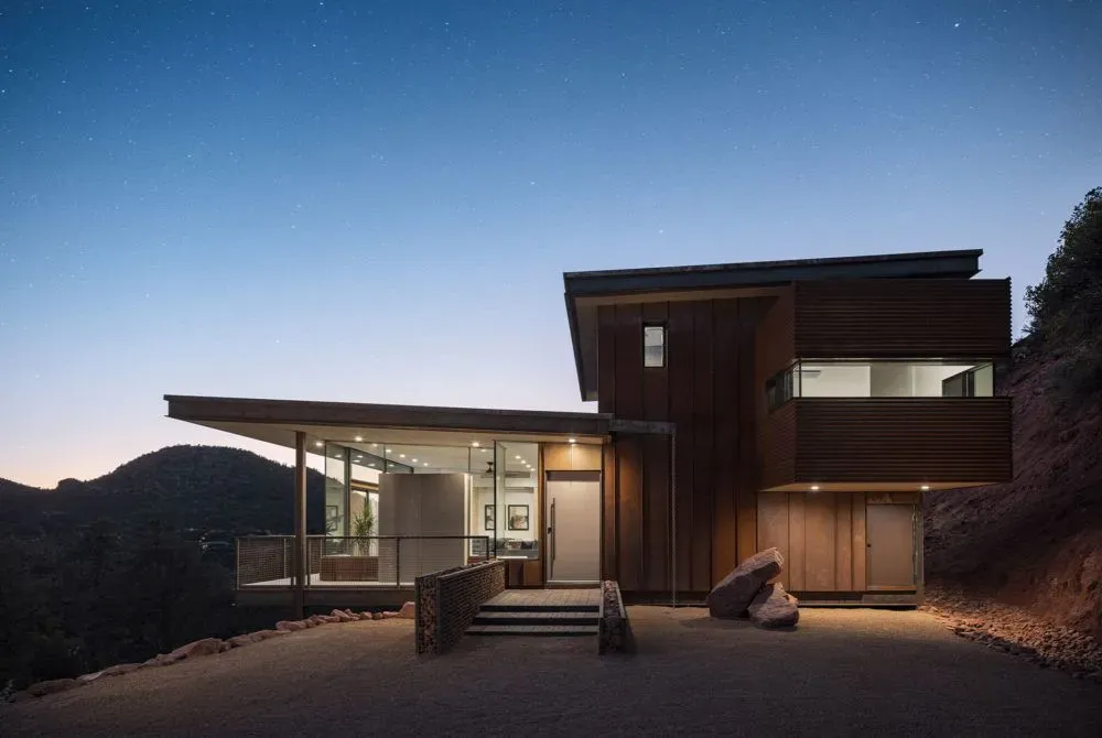 Modern house with large glass windows at dusk