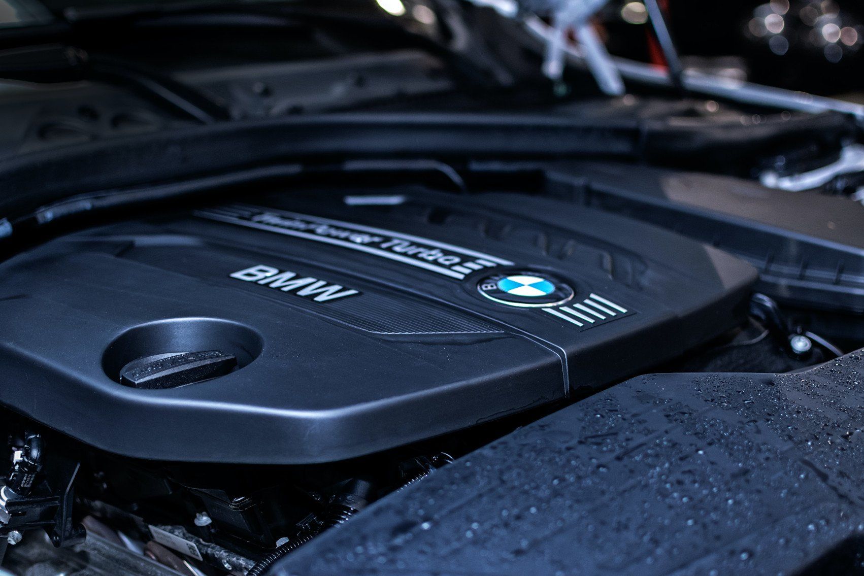 A close up of a bmw engine with the hood open