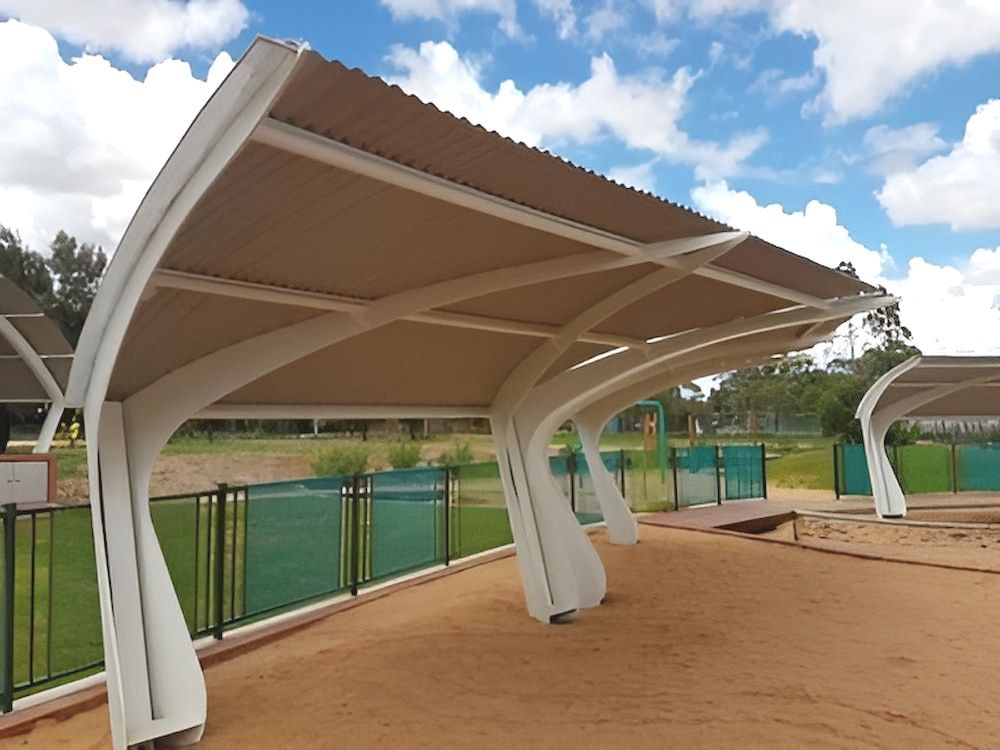 A Row Of Covered Parking Spaces With A Fence — Jakes Steel & Welding in East Arm, NT