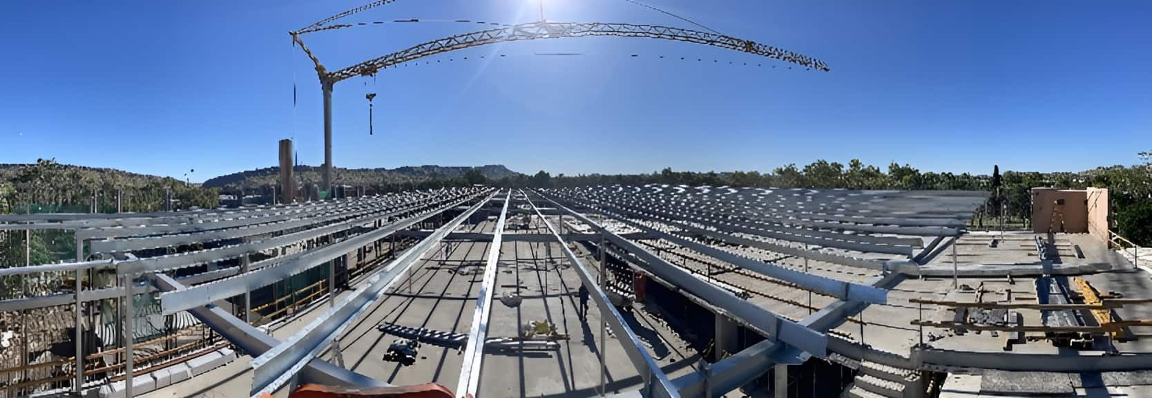 A Large Metal Structure Is Being Built With A Crane In The Background — Jakes Steel & Welding in East Arm, NT