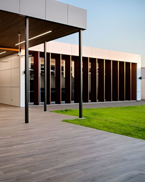 A Large Building With A Wooden Deck In Front Of It — Jakes Steel & Welding in East Arm, NT
