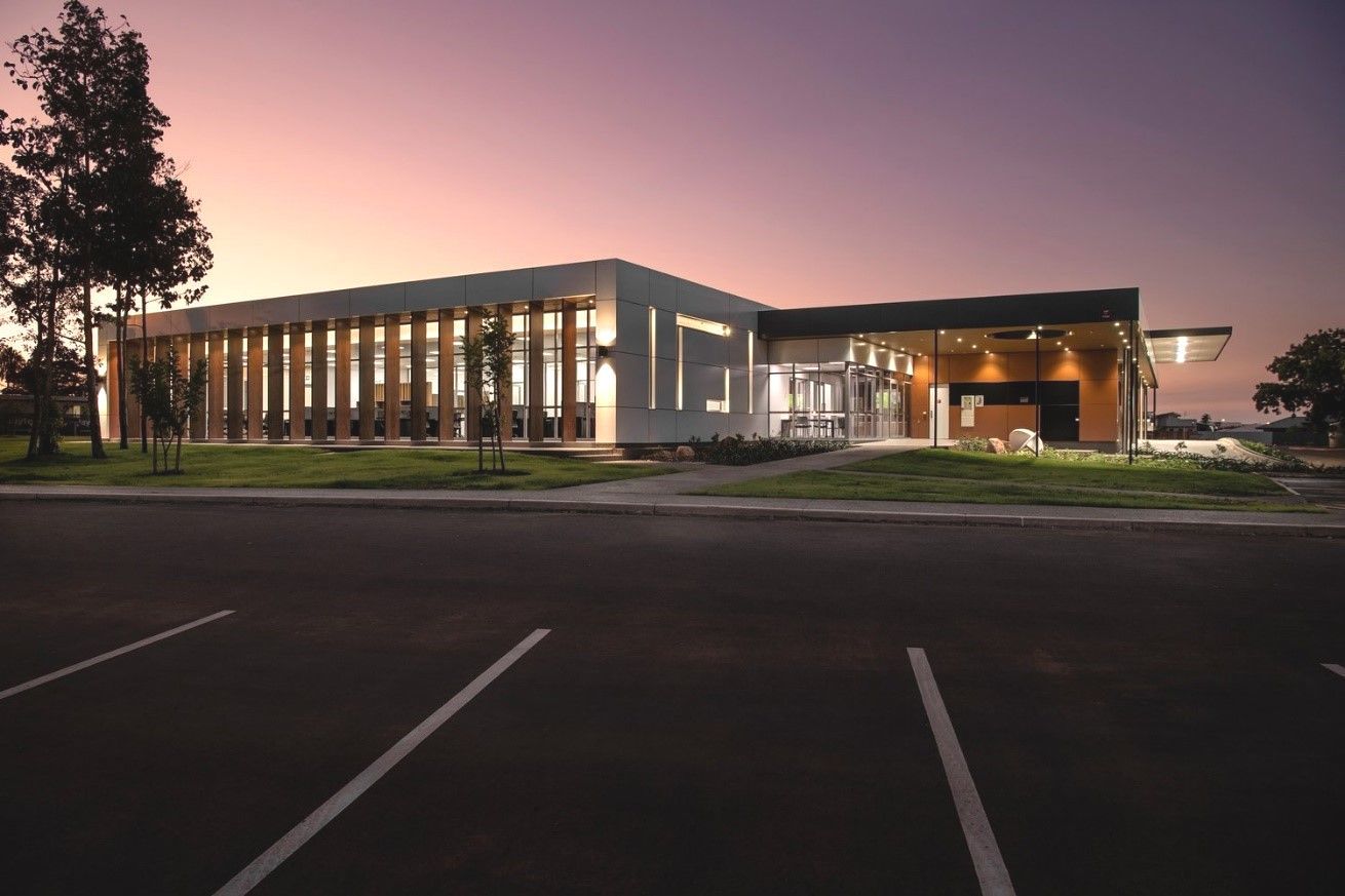 A Large Building With A Lot Of Windows Is Lit Up At Night — Jakes Steel & Welding in East Arm, NT