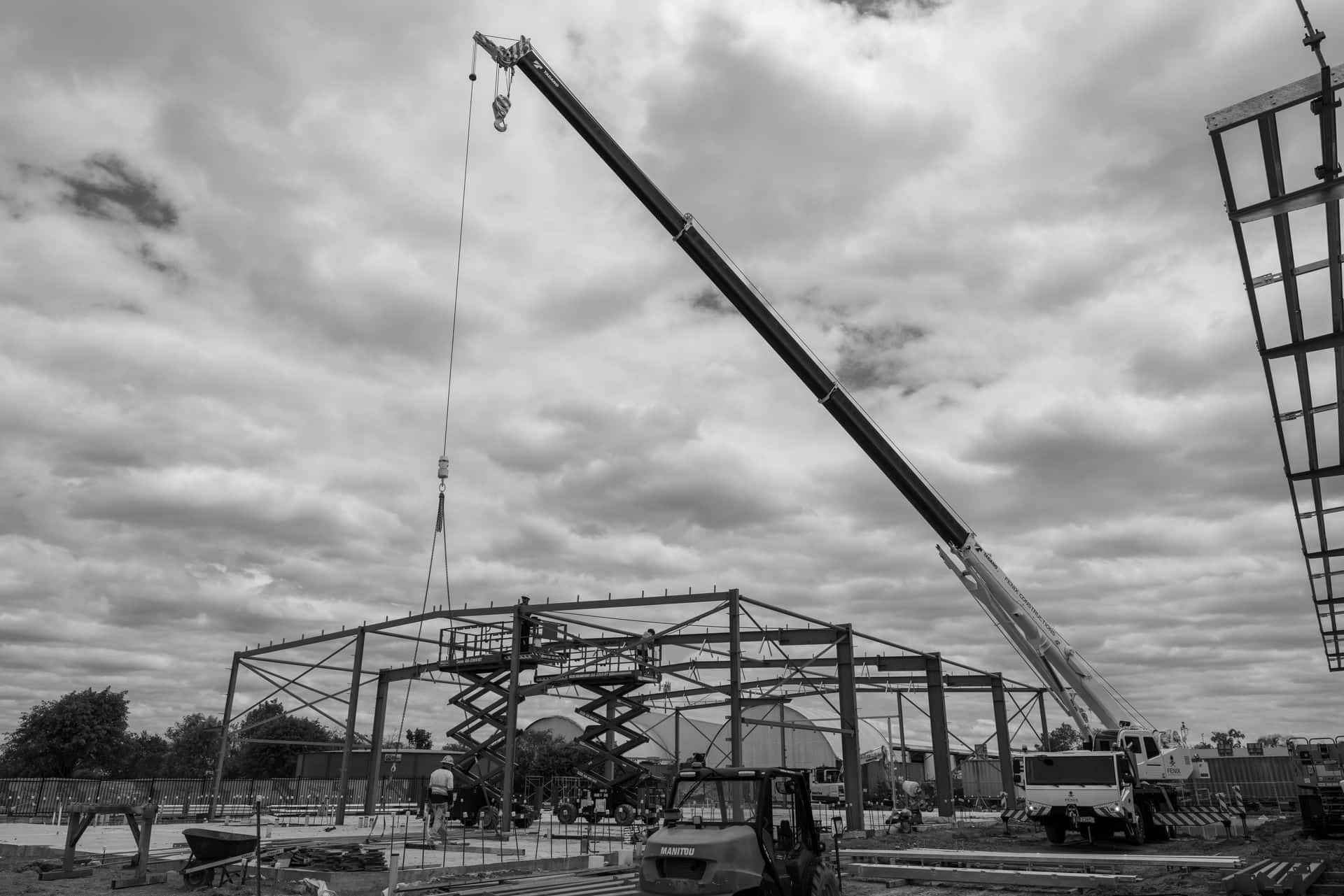 A Black And White Photo Of A Construction Site With A Large Crane  — Jakes Steel & Welding in East Arm, NT