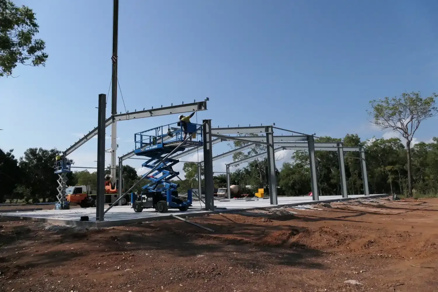 A Large Metal Structure Is Being Built In A Dirt Field — Jakes Steel & Welding in East Arm, NT
