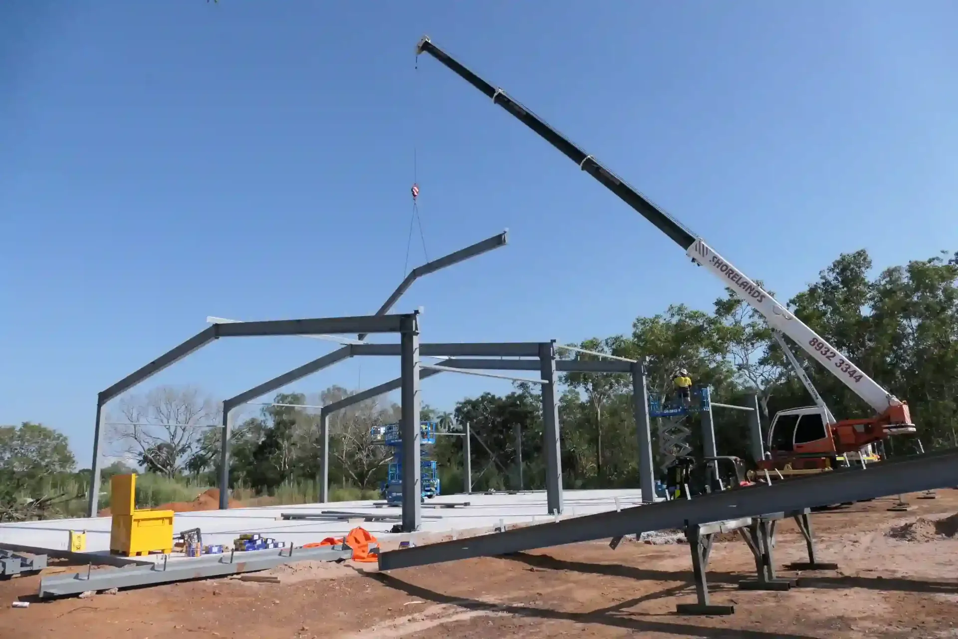 A Large Crane Is Being Used To Build A Building — Jakes Steel & Welding in East Arm, NT