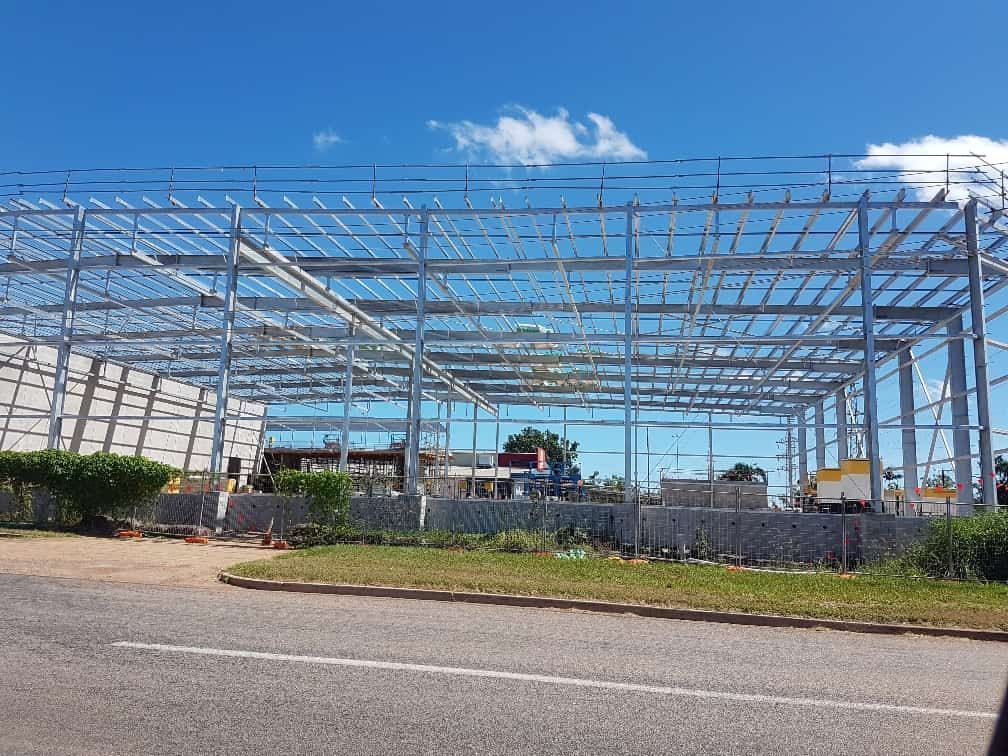 A Large Metal Structure Is Being Built Next To A Road — Jakes Steel & Welding in East Arm, NT