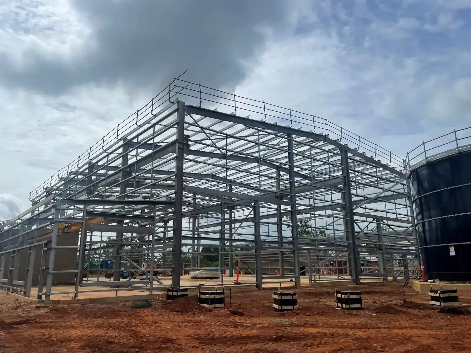 A Large Metal Structure Is Being Built In The Middle Of A Dirt Field — Jakes Steel & Welding in East Arm, NT