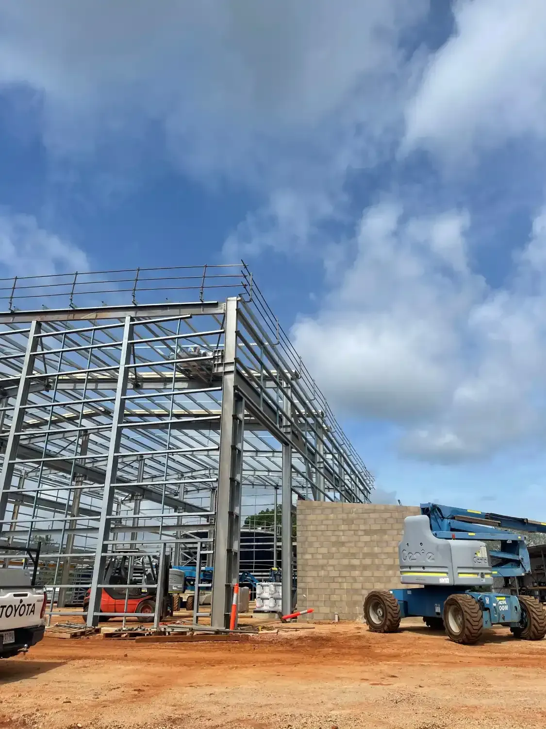 A Large Metal Structure Is Being Built In A Dirt Field — Jakes Steel & Welding in East Arm, NT