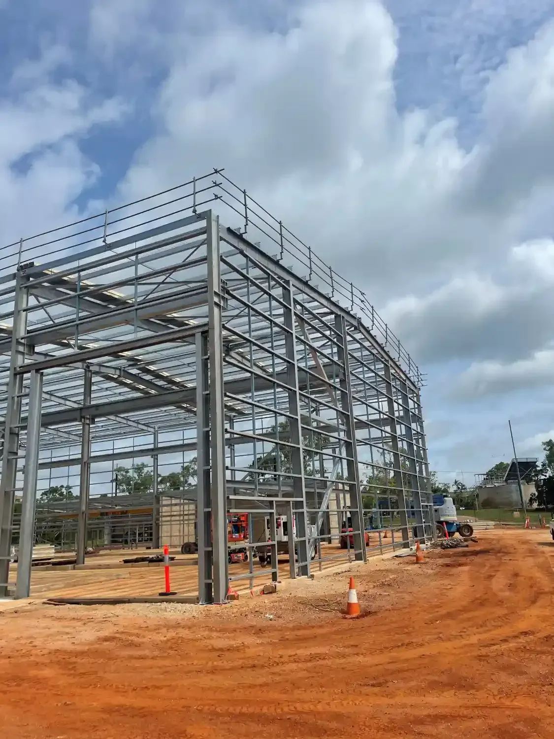 A Large Metal Structure Is Being Built In A Dirt Field — Jakes Steel & Welding in East Arm, NT