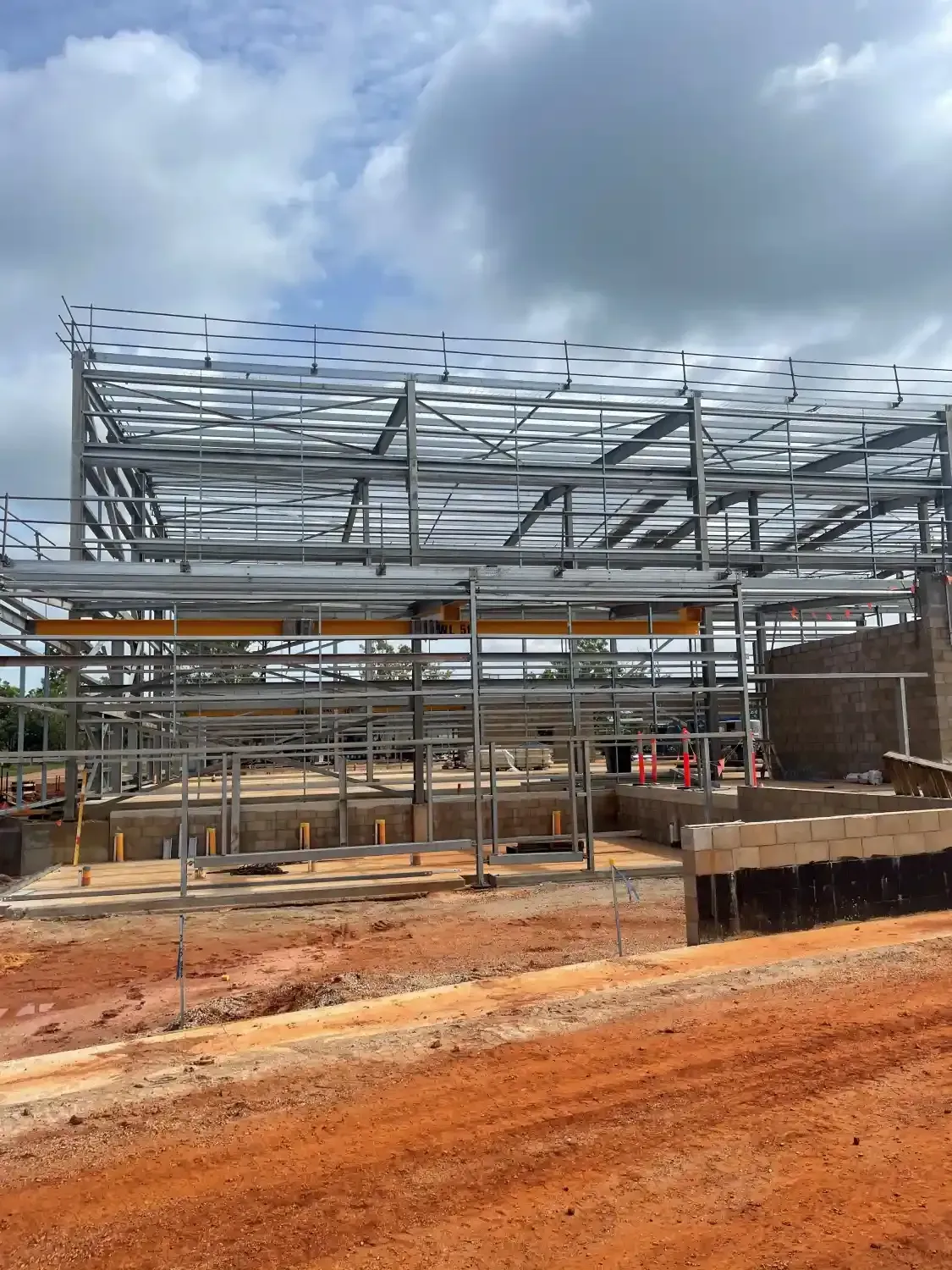 A Large Metal Structure Is Being Built On A Dirt Road — Jakes Steel & Welding in East Arm, NT