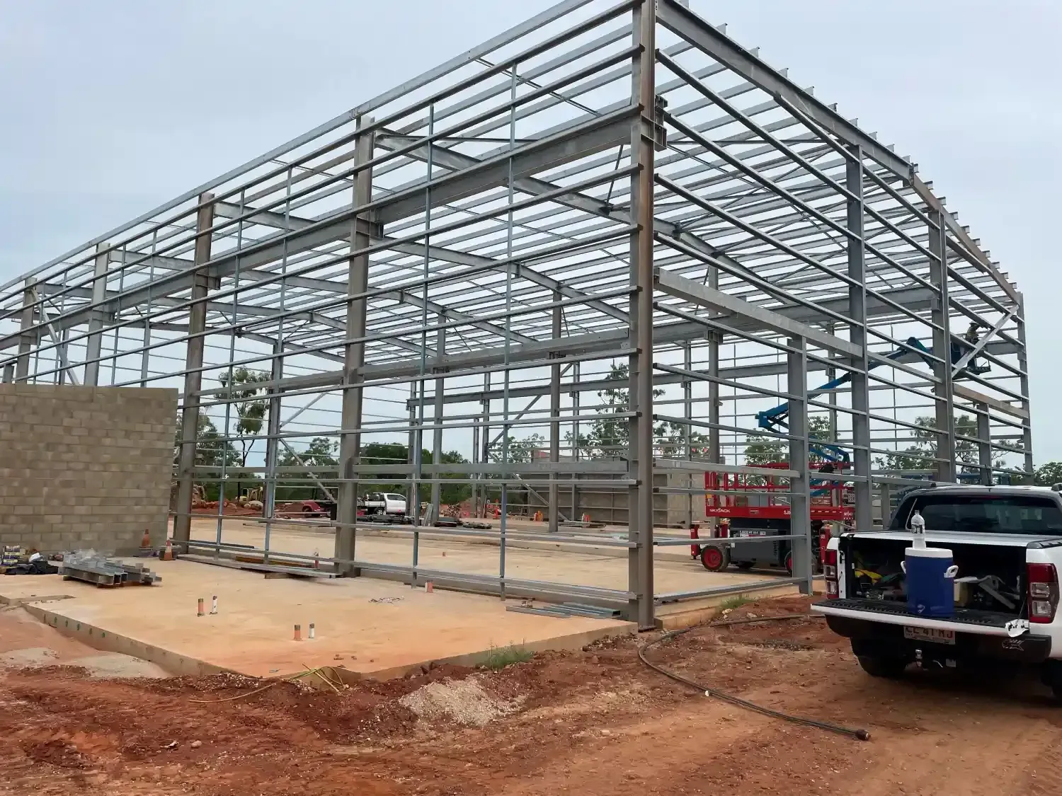 A Truck Is Parked In Front Of A Large Metal Structure Under Construction — Jakes Steel & Welding in East Arm, NT