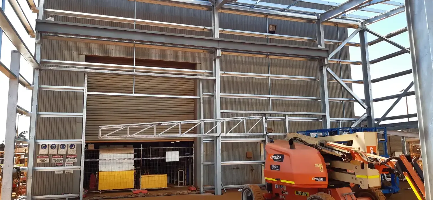 A Large Building Under Construction With A Crane In The Middle Of It — Jakes Steel & Welding in East Arm, NT