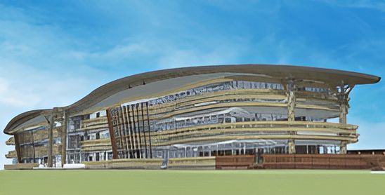 A Large Building With A Curved Roof Is Sitting On Top Of A Lush Green Field — Jakes Steel & Welding in East Arm, NT