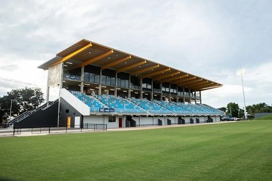 A Large Stadium With Blue Seats And A Wooden Roof — Jakes Steel & Welding in East Arm, NT