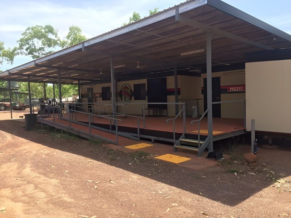 A Large Building With A Ramp And Stairs In Front Of It — Jakes Steel & Welding in East Arm, NT