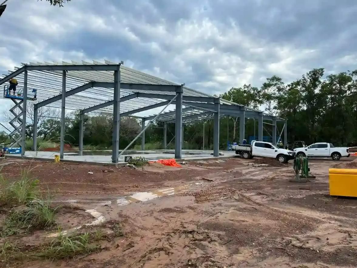 A Big Metal Structure Is Being Built In A Dirt Field — Jakes Steel & Welding in East Arm, NT