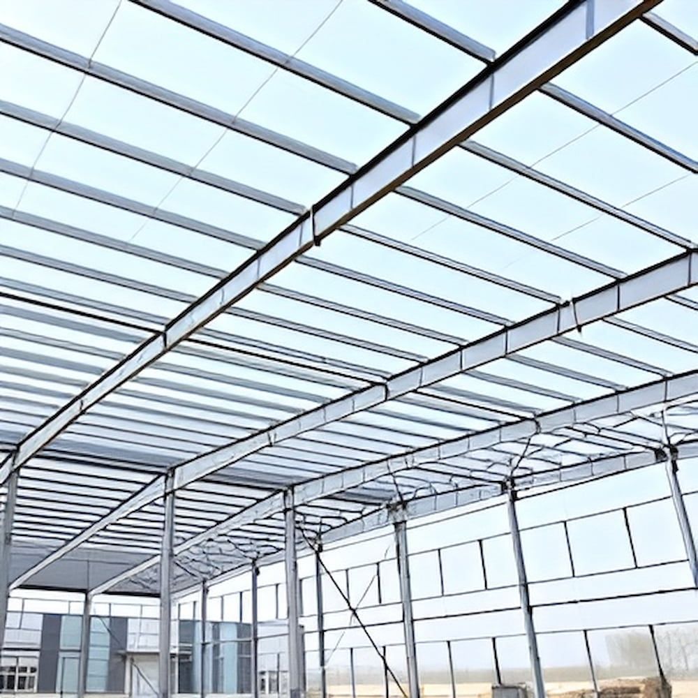 A Large Metal Structure With A Clear Roof Is Under Construction — Jakes Steel & Welding in East Arm, NT