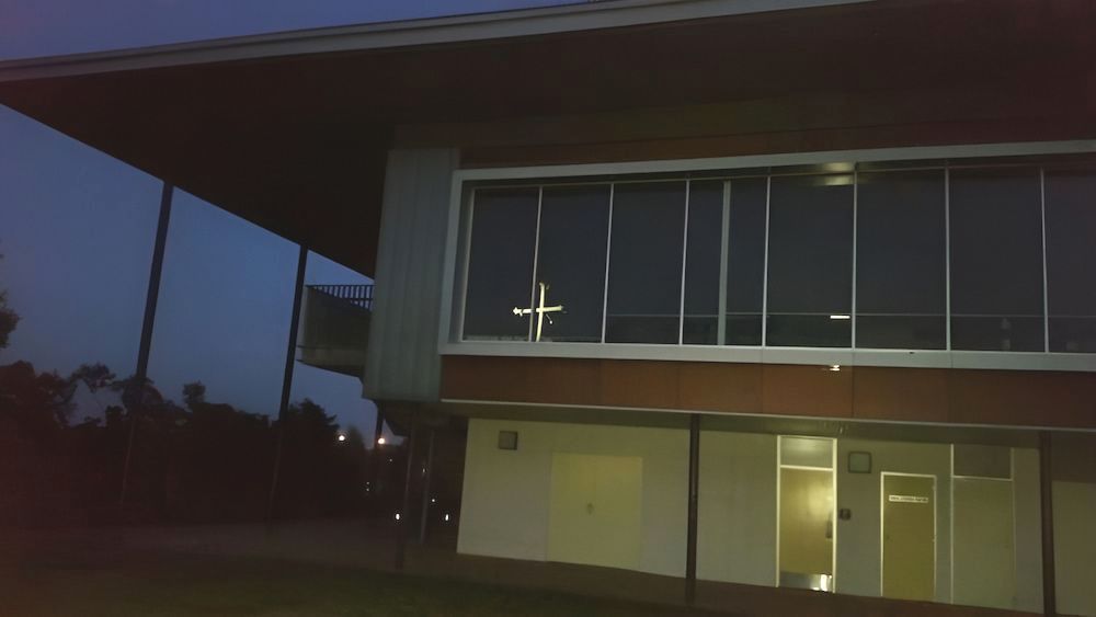 A Large Building With A Cross In The Window At Night — Jakes Steel & Welding in East Arm, NT