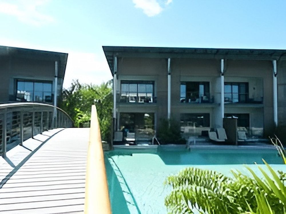 A Large Building With A Swimming Pool In Front Of It — Jakes Steel & Welding in East Arm, NT