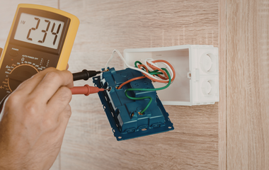 Electrician checking wiring inside a residential electrical box