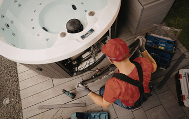 Technician working on wiring for a hot tub installation