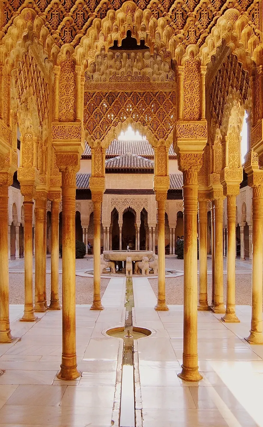 Ornate columns and arches of a Moorish palace in shades of gold and beige.