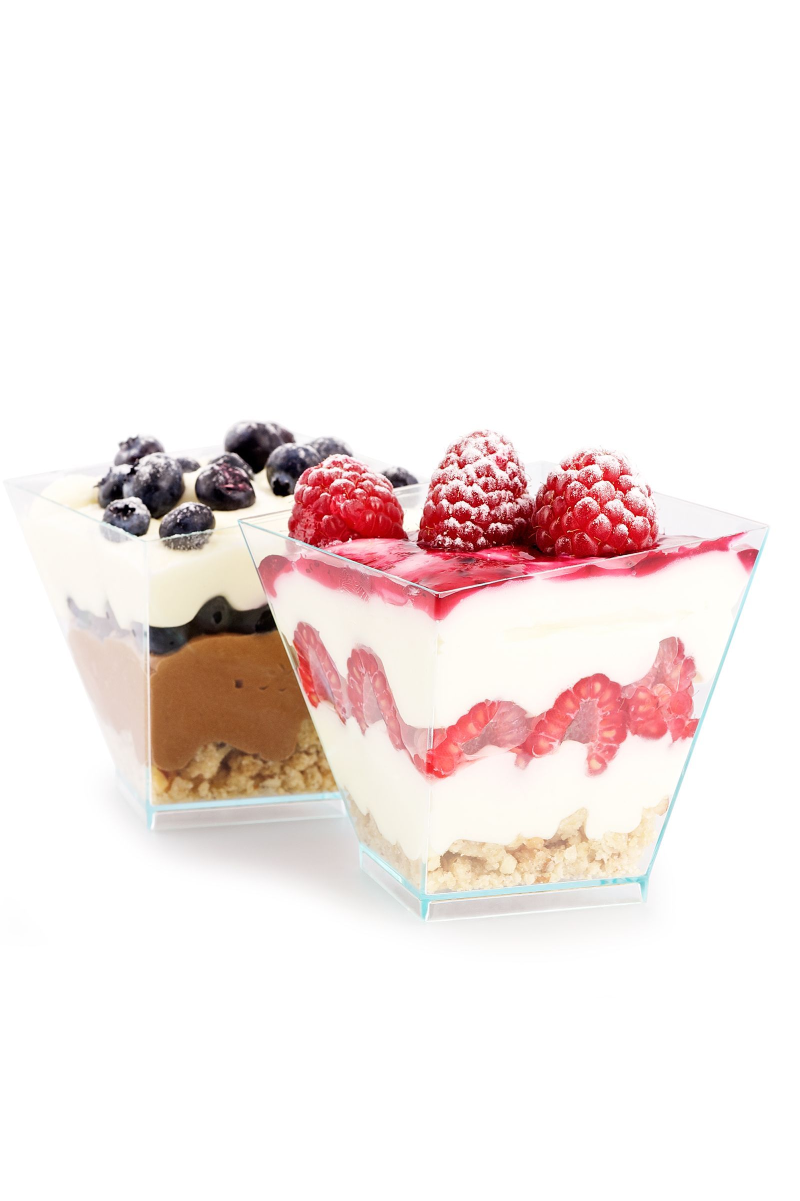 Two dessert cups: one with blueberries and chocolate, the other with raspberries and cream.