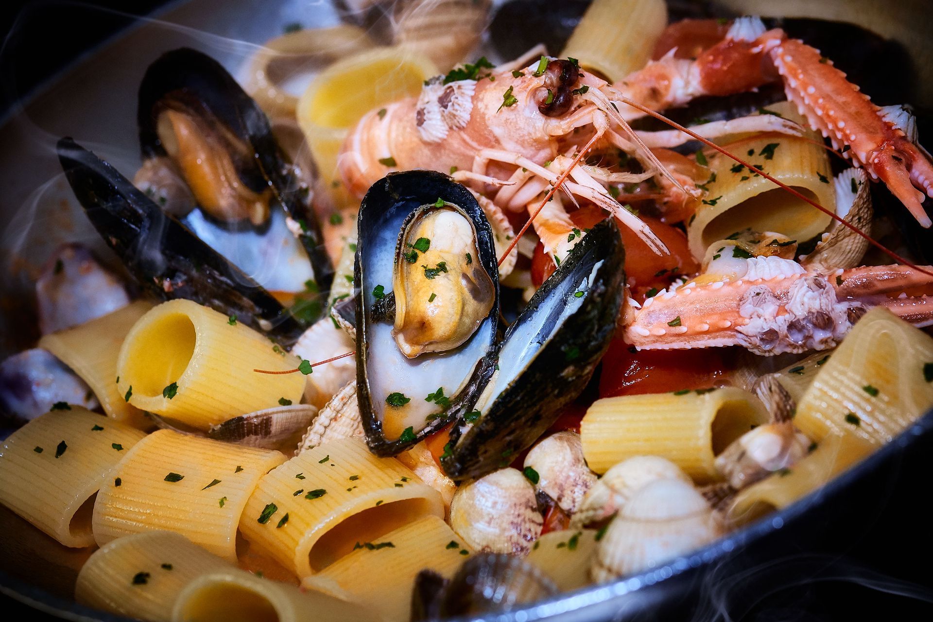 Pasta dish with mussels, shrimp, and other seafood.