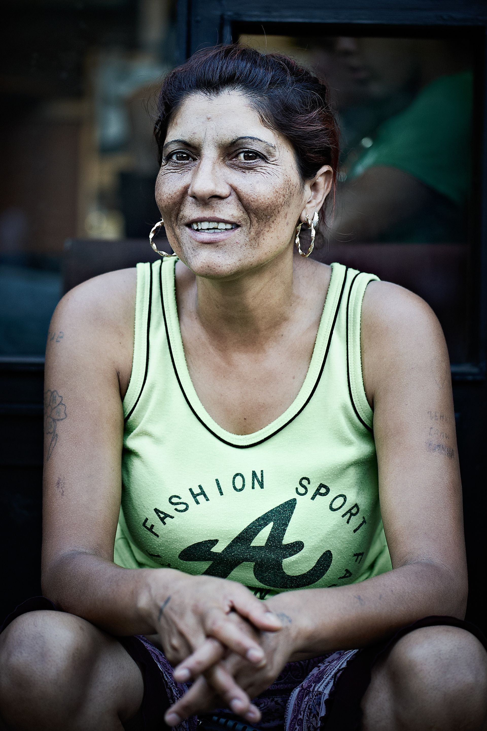 Woman in a light green tank top with