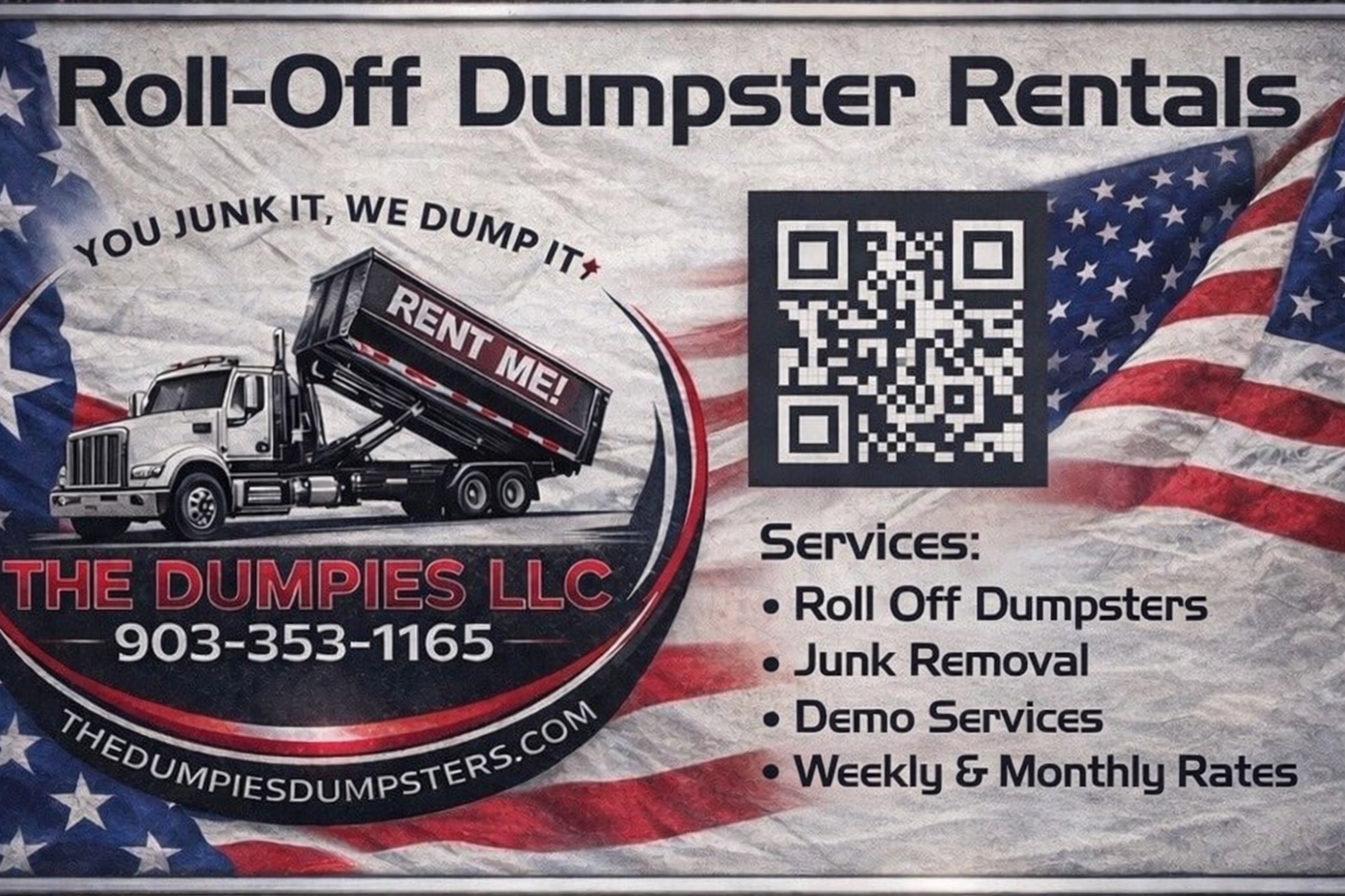 Two black dumpsters are parked in a dirt lot in front of a pile of trash.