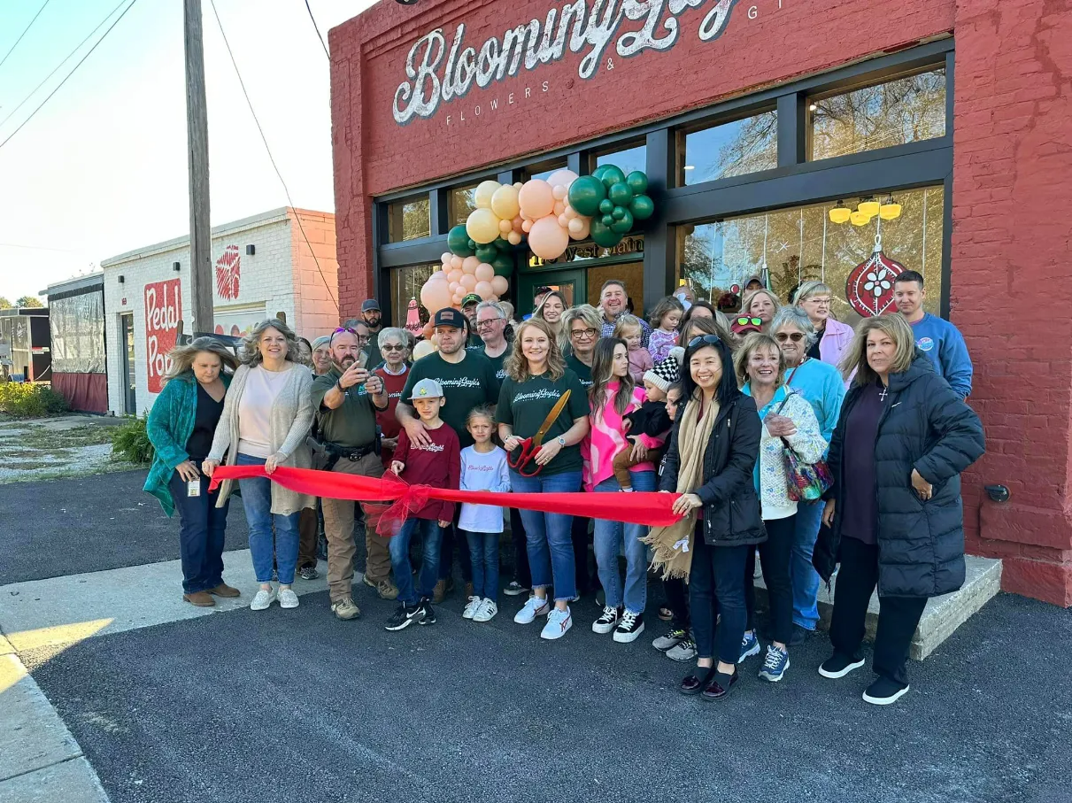 People cut a red ribbon at