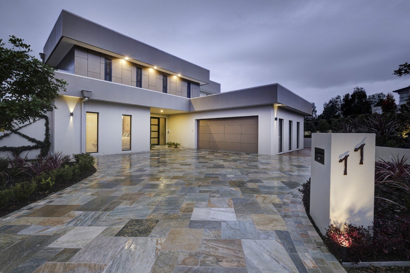 Yarrum custom designer homes two storey home with stone tiled driveway, garage, and modern facade