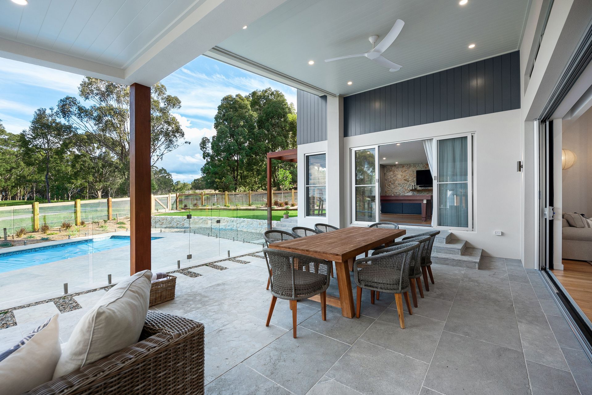 Yarrum custom designer patio featuring outdoor dining, ceiling fan, and poolside relaxation