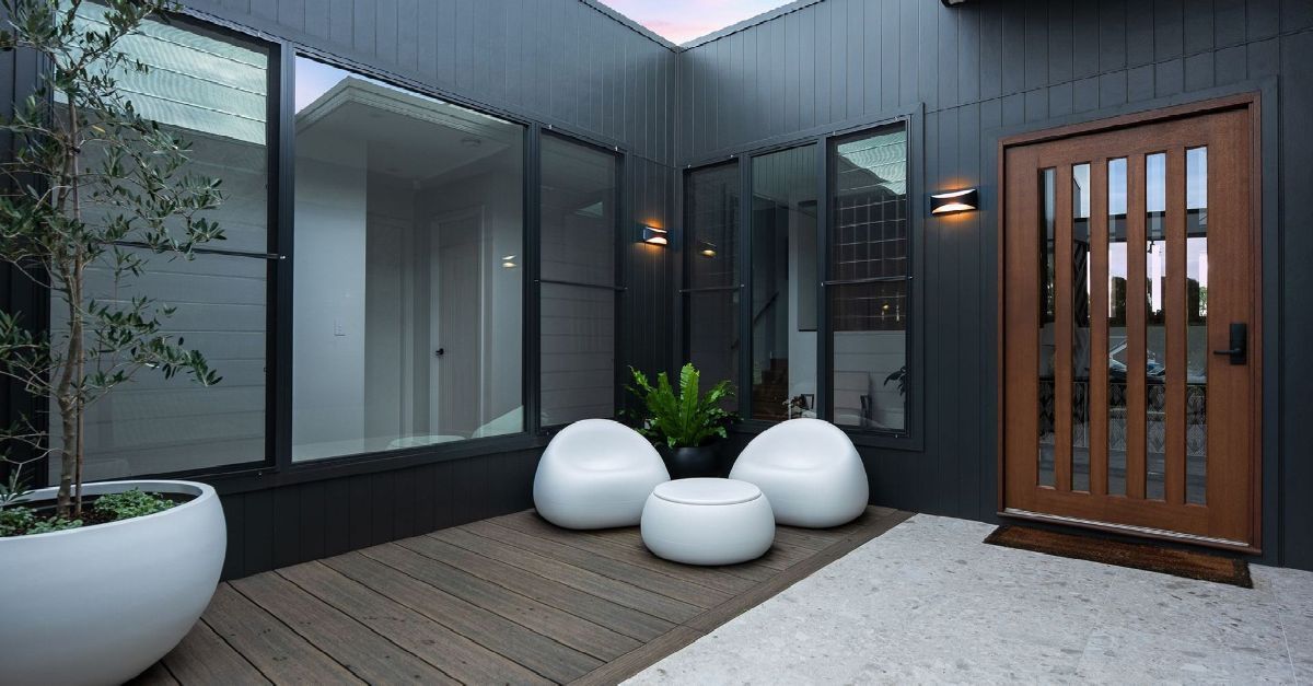 Yarrum Designer Homes custom entrance with contemporary timber door, large windows and potted plants