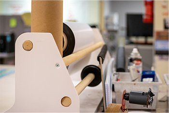 White paper roll dispenser in office setting.