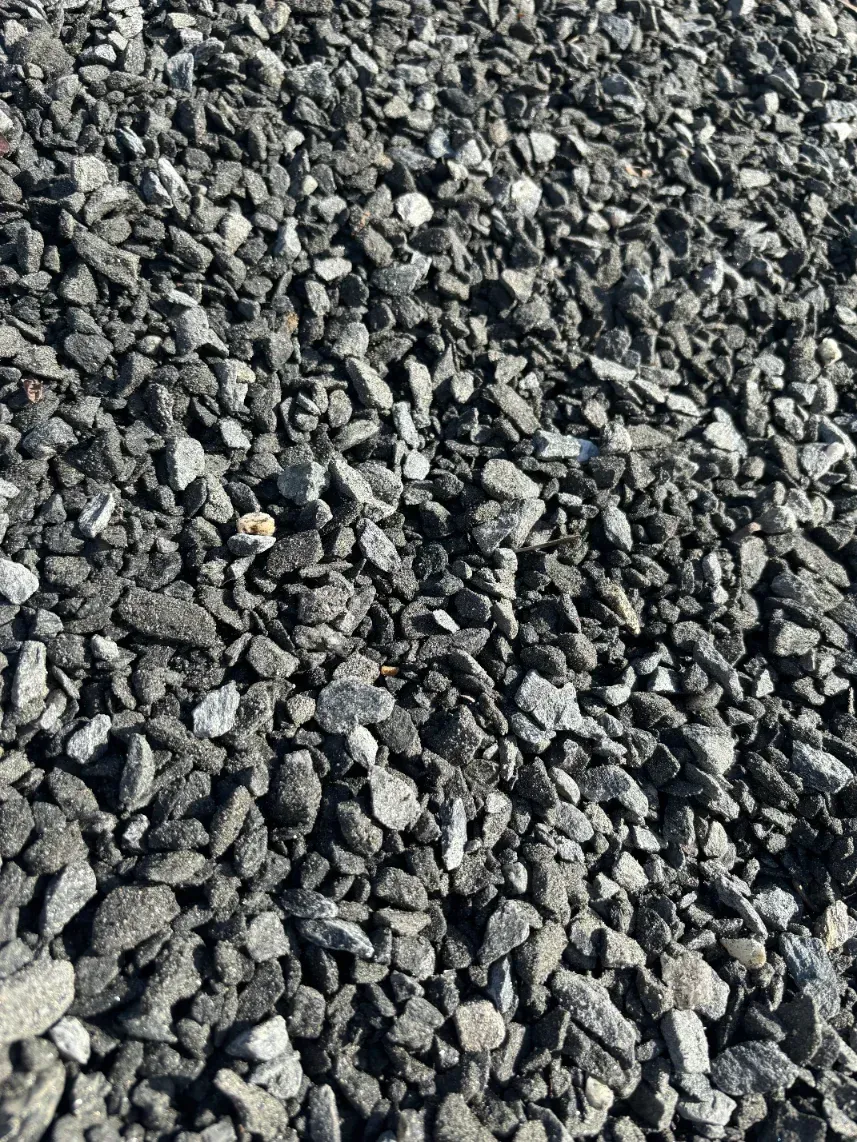Close-up of dark gray gravel or crushed stone covering the ground