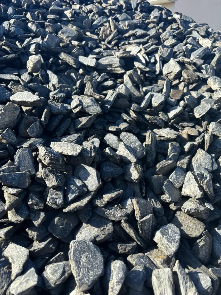 Pile of dark gray crushed rocks or gravel filling the frame