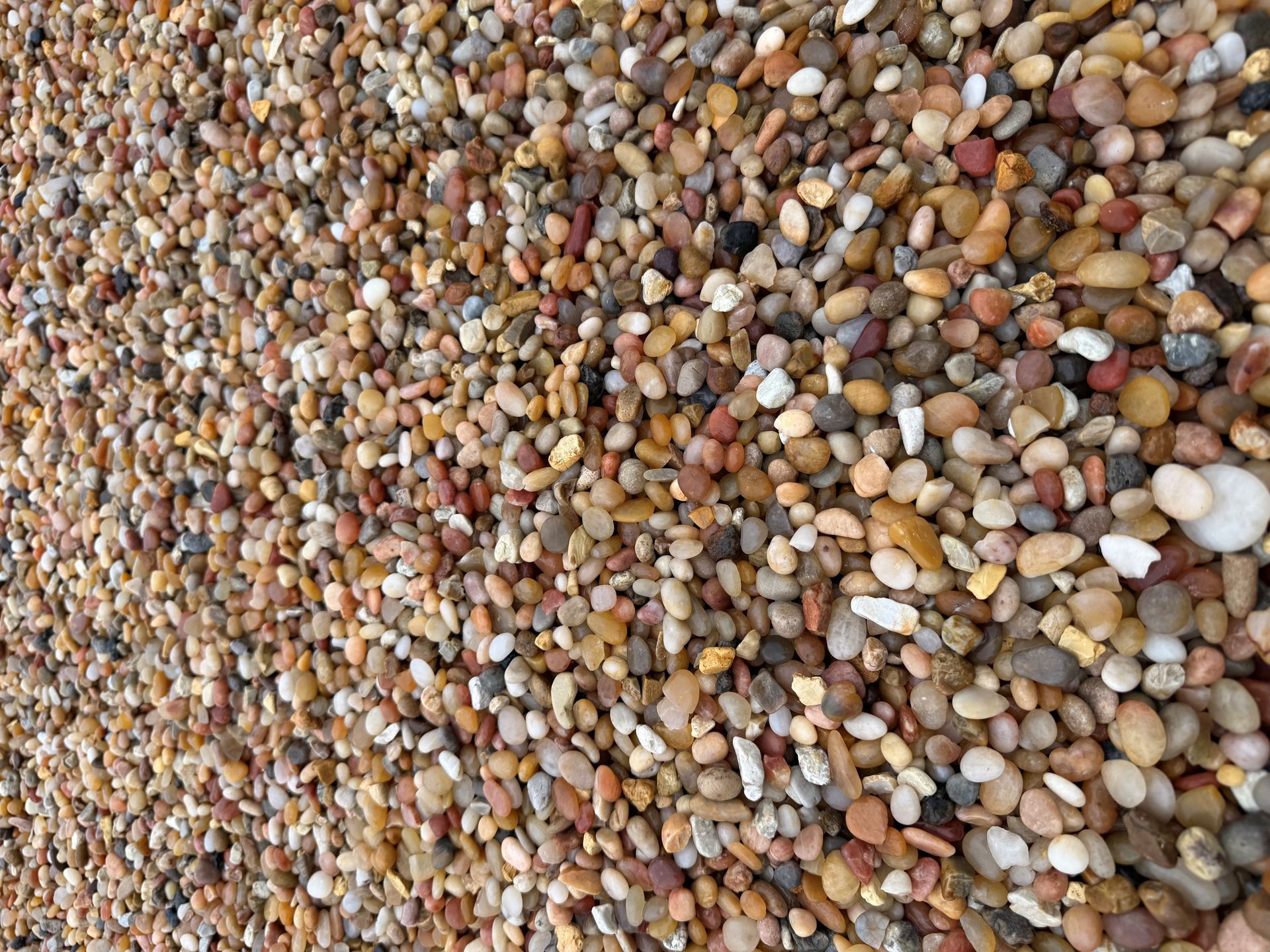 Close-up of multicolored pebbles and small stones filling the frame