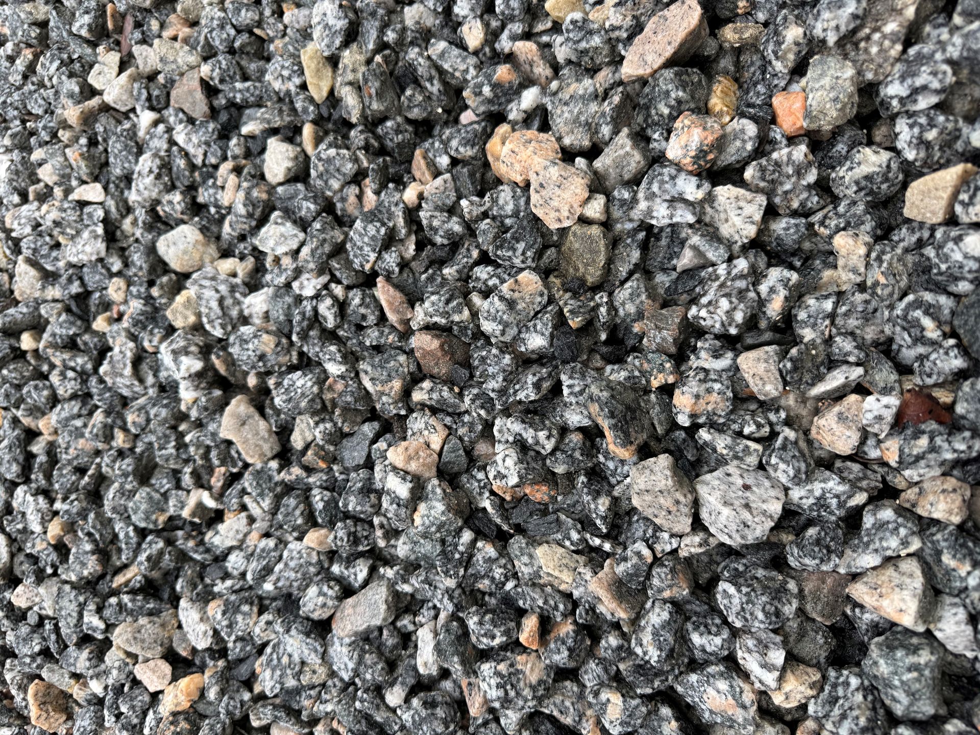 Close-up of gray and tan gravel stones with rough textures.