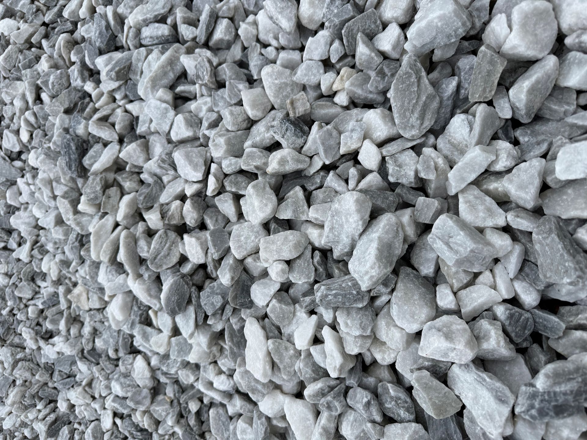 Close-up of small gray crushed stones or gravel filling the frame