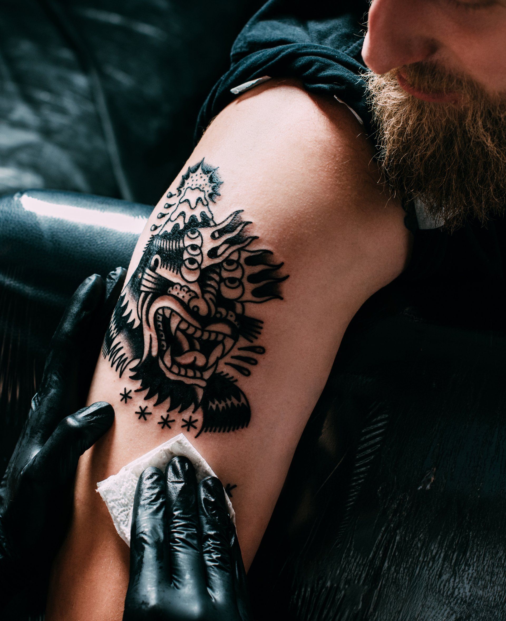 Tattoo Artist with His Client — South Bend, IN — Electric Rose Inc Tattoo Artist with His Client — South Bend, IN — Electric Rose Inc