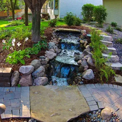 Garden waterfall feature installation in Loretto MN adding soothing sound and visual appeal to landscapes