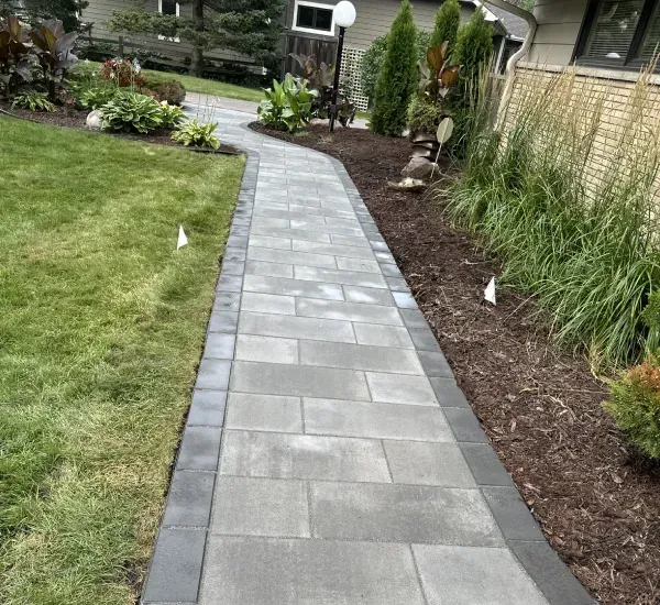 Custom walkway installation in Loretto MN creating safe and attractive outdoor paths for residential landscapes