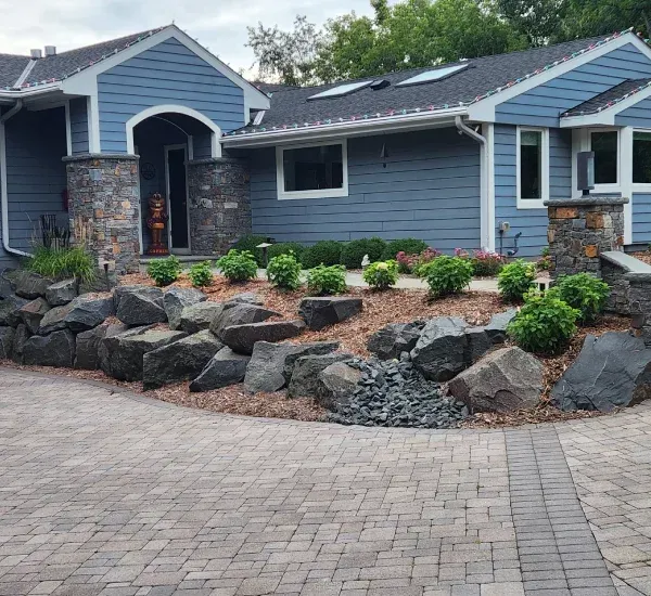 Decorative boulder installation in Loretto MN enhancing landscapes with natural stone focal points