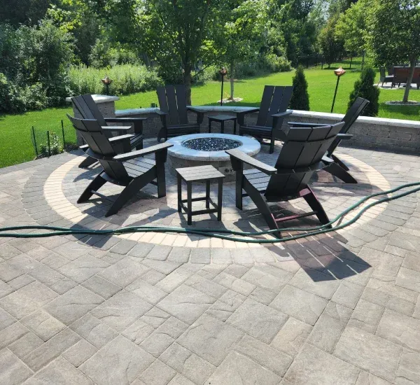 Fire pit installation in Loretto MN creating warm and inviting outdoor gathering spaces for residential backyards