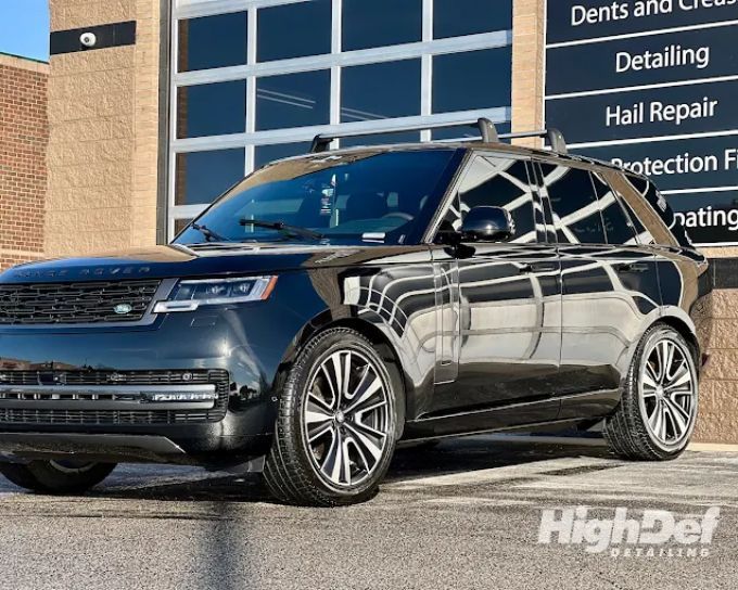 Black Range Rover SUV in the shop showing auto window tinting film types for cars