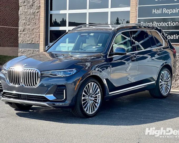 Gray BMW X7 SUV outside the studio showing auto window tinting film types for cars